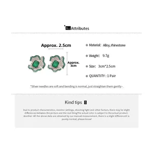Macro detail of luxury flower earrings with emerald green gemstone and crystal rhinestones