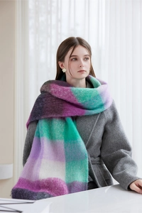 Detail of soft purple and green plaid thick scarf with fringes and wool texture