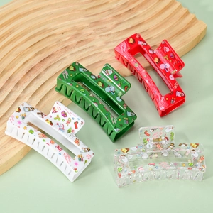 Set of four Christmas hair claws with festive prints in red, green, and white