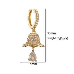 Detail showing 35mm gold Christmas bell earrings with zircon drops on white background
