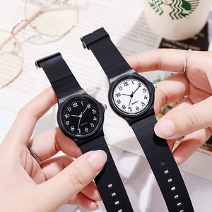 Close-up of minimalist black and white quartz watches with flexible rubber straps