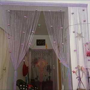 Detail view of purple string curtain with small pink rose floral decor for home partition
