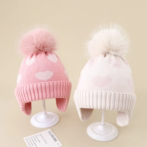 Winter girls knitted earflap hats with heart patterns and fluffy faux fur pompoms