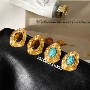 Retro stainless steel gold earrings set with tiger eye and turquoise on leather bag