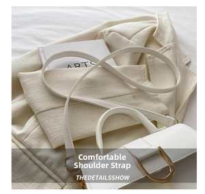 Detail of white leather shoulder bag with gold D-ring and comfortable strap design