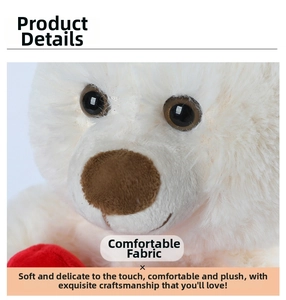 Close-up of the plush teddy bear face showing soft long-hair ivory fabric and brown nose