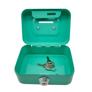 Detail view of an open green metal piggy bank with a silver key on white background