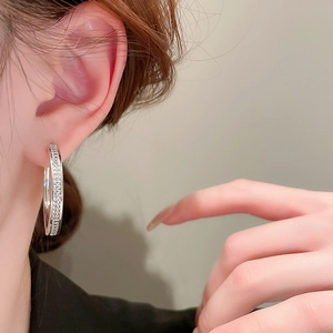Close-up of elegant silver hoop earrings with shimmering pave-set cubic zirconia crystals