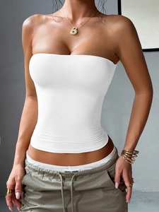 Detailed view of a slim fit white strapless tube top on a model in a modern style