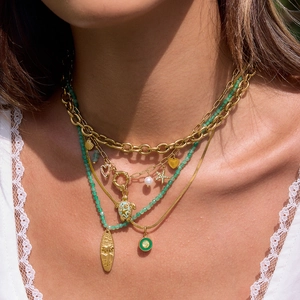 Layered gold necklace set with green beads and ocean-themed seashell charms