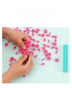 Detail of hand arranging DIY alphabet and number stamps for cookie and fondant baking