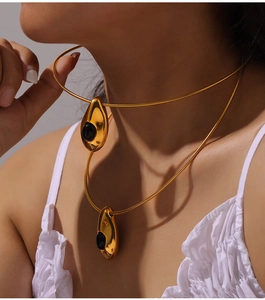 Close-up of double-layer titanium necklace with water drop pendant and black agate