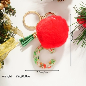 Detailed Christmas letter C keychain with red pompom, green tassel, and resin snowman insert