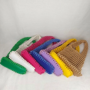 Detailed close-up showing seven colors of woven mesh beach bags with durable solid bases