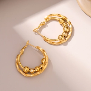 Twisted gold hoop earrings with double layer design and five polished metal beads