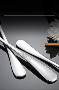 Macro detail of thickened stainless steel fork handle with mirror polished finish