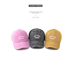 Three vintage mesh trucker hats in pink, grey, and yellow with embroidered text detail