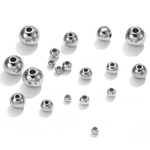 Close-up of assorted silver 304 stainless steel beads with holes for DIY jewelry making