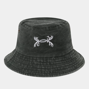 Detail of embroidered pattern and metal eyelets on washed cotton bucket hat