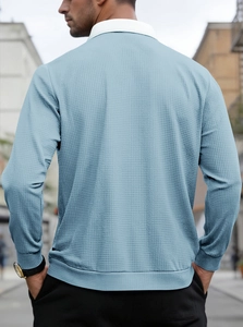 Detailed back view of men's light blue waffle knit polo shirt with white collar detail