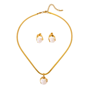 Elegant gold snake chain necklace and earring set with white pearls on a white background