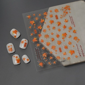 Autumn maple leaf nail art stickers with orange gradient designs and embossed textures