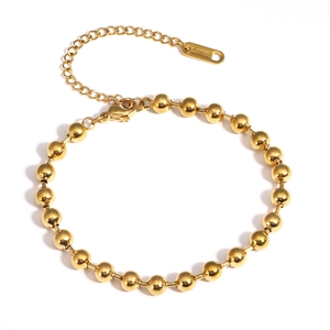 Détail d'un bracelet à billes en acier inoxydable doré avec fermoir réglable et poinçon S.STEEL