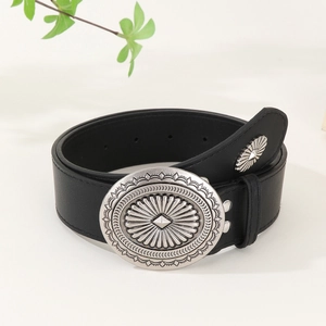 Vintage black leather belt with oversized silver oval buckle featuring sunburst engraving