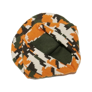 Close-up of thick knitted fabric texture with orange digital camouflage pattern