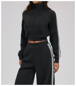 Close-up of white side stripes on black windproof hoodie and wide-leg sports pants