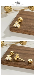 Detail view of 18K gold cluster stud earrings with three zircons and screw back closure