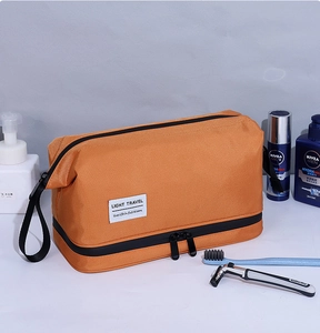 Detail view of orange toiletry bag with dry-wet separation and dual zipper design