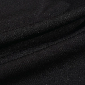 Detailed macro view of the black knit fabric texture and elegant pleated material