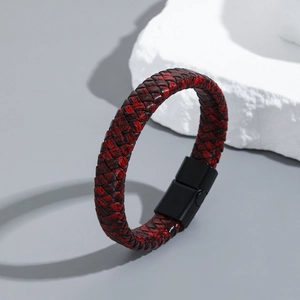Macro shot of red and black braided leather bracelet featuring a black magnetic alloy clasp