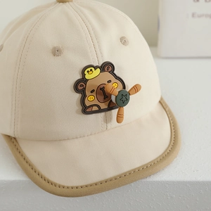 Beige baby baseball cap with bear patch and a rotating propeller accessory on top