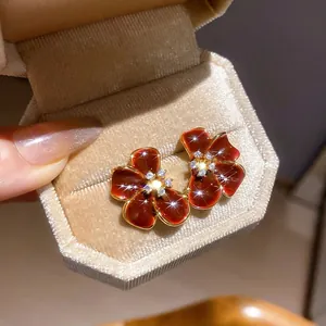 18K gold plated flower stud earrings with red enamel petals and cubic zirconia