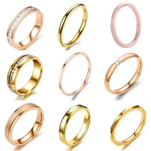 Collection of nine minimalist stainless steel rings in gold, rose gold and pink finishes