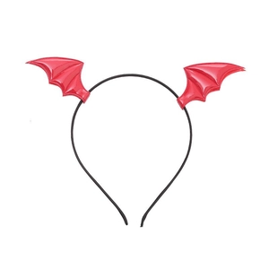 Detail of glossy red bat wings on a black headband for Halloween party costumes