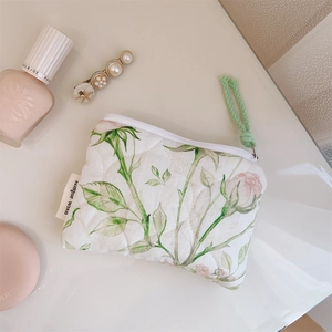 Detailed macro view of floral quilted cotton pouch for lipsticks and small accessories