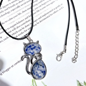 Cat shaped natural crystal pendant with silver alloy frame on a black leather cord necklace