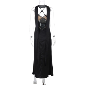 Detail of backless black maxi dress featuring lace patchwork and criss-cross straps