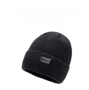 Detail of black cable knit beanie with thick thermal texture and sewn FUMY brand patch