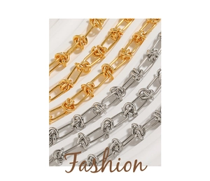 Close-up of hip-hop punk knotted chain links in gold and silver titanium steel
