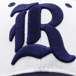 Macro shot of 3D embroidery letter R on navy and white twill baseball cap fabric