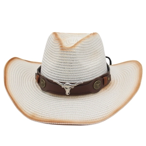 White straw cowboy sun hat with wide brim, brown burnt edges and bull head metal ornament