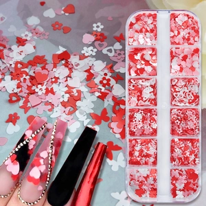 Close-up of 12-grid box with heart, flower and butterfly nail sequins in red and white