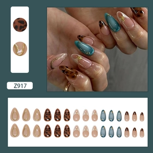 Leopard print almond press-on nails with peacock blue cat-eye and gold 3D line designs