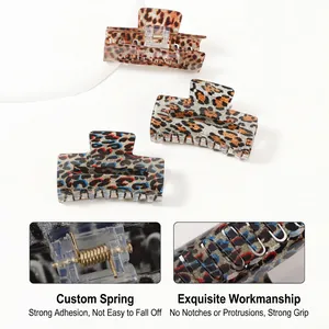 Set of three leopard print hair claw clips in brown, grey, and colorful resin patterns