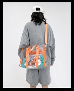 Detailed back view of model wearing a transparent PVC tote bag with orange trim accents