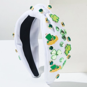 Detail of St. Patrick's Day headband with green rhinestones and Luck shamrock charms